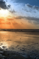 lone surfer surfing the winter tides