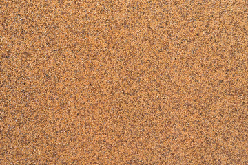Background. Small orange pebbles on a wall