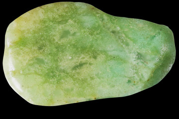 small chrysoprase pebble macro, isolated on black background