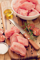 raw turkey on white dish on brown wooden background