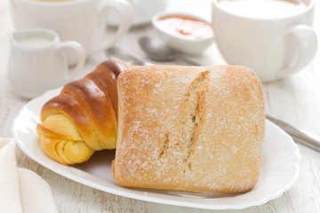 bread with coffee on white wooden background