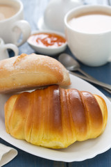 croissant and bread with coffee on blue wooden background