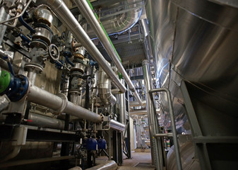 Equipment, cables and piping as found inside of a modern industr