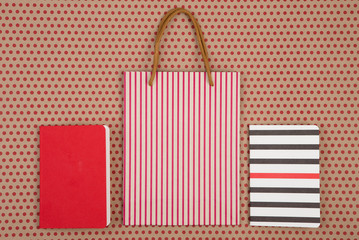 Fototapeta na wymiar handmade striped shopping bag, gift bags and notepads on craft
