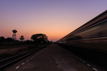 Fototapeta na wymiar Train moving to the station in sunset