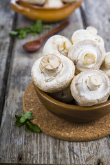 Raw mushrooms on a wooden table