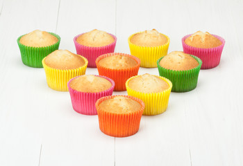 Homemade Colorful Plain Cupcakes On White Table.