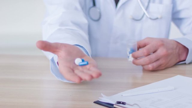 Professional doctor giving pills