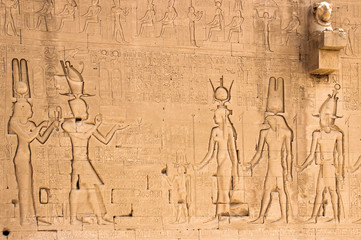 The south wall of the temple of Hathor at Dendera with lion-headed waterspouts. Cleopatra and her son Caesarian (on the left side)