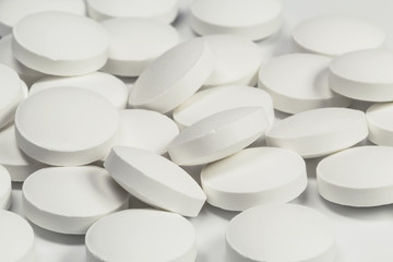 White pills on white background