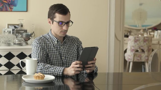 Young Man with Tablet Computer in Home.