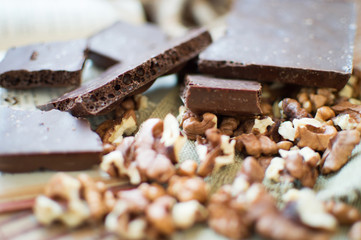 Chocolate and nuts lying on a table.