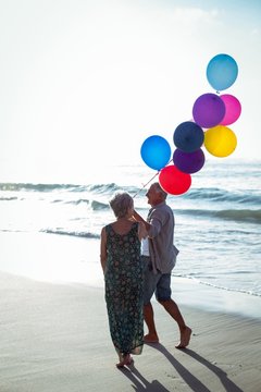 Senior Couple Holding Balloons 