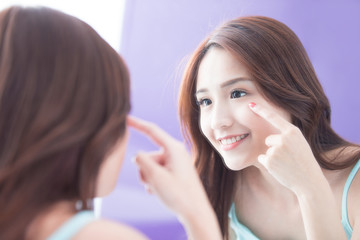 Smile woman touch eye