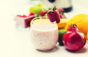 close up of glass with milk shake and fruits