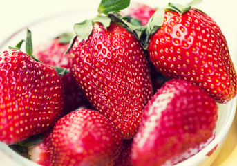 close up of ripe red strawberries over white