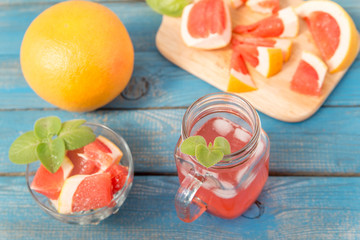 close up of fresh delicious oranges and grapefruit on an old wooden background