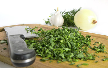 Chopped herbs on kitchen board
