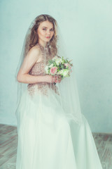 Fototapeta na wymiar Beautiful bride in wedding dress. Portrait of young bride. Studio shot. 