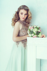 Beautiful bride in wedding dress. Portrait of young bride. Studio shot.
