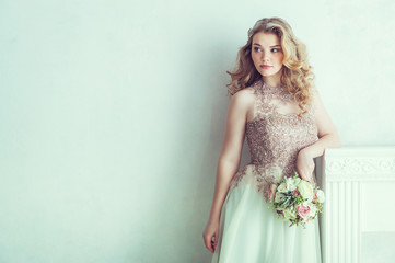 Beautiful bride in wedding dress. Portrait of young bride. Studio shot.
