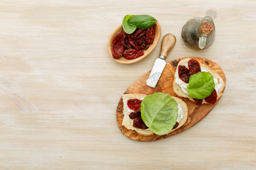 Sandwiches with mascarpone, dried tomatoes, basil