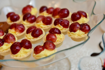 Cupcakes with vanilla and grapes on top