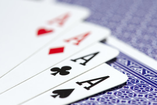 close up of four aces on a deck of cards