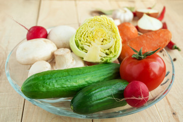 Fresh vegetables, mushrooms, spices on a wooden table