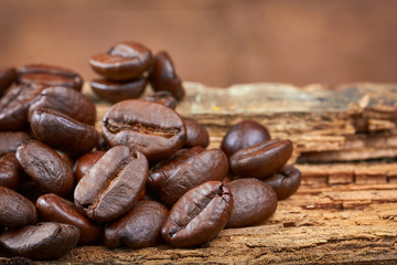 Coffee beans on wood background. Close-up