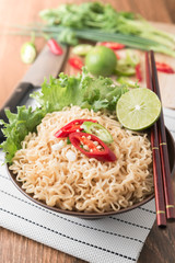 chilli on instant noodles in bowl and vegetable background