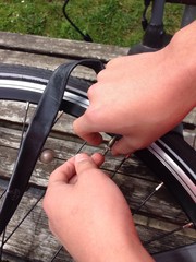 teenage boy repairing a flat tire