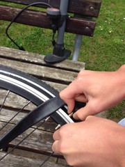 teenage boy repairing a flat tire