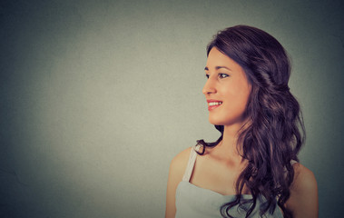 Portrait of a pretty happy woman isolated on gray wall background