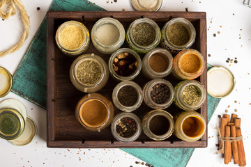 Closeup spices and herbs jars. Food, cuisine ingredients. Wooden box.