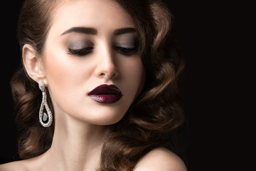 Beautiful brunette in  Hollywood manner with curls, dark lips. Beauty face. 