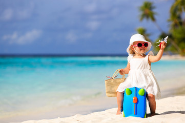 cute little girl travel on summer beach