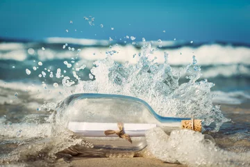 Papier Peint photo Eau Message in the bottle coming with wave from ocean