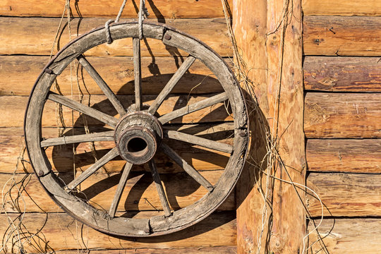 decorative wheel hanging on a Russian log hut
