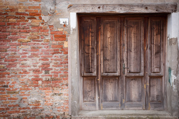 Old wooden locked door with peeling paint