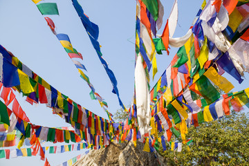 tibetan flags with mantra on sky background