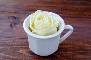 A cup of coffee and a white rose, spring