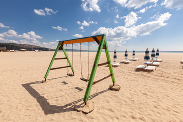 Playground swing on the beach