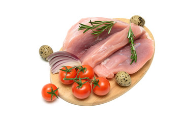 pork, vegetables and quail eggs on a cutting board
