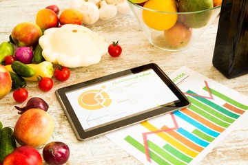 Organic food and a Tablet PC showing information about healthy nutrition and phytochemical...