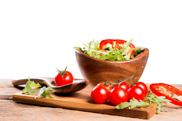 salad in a wooden salad bowl. Tomato, mozzarella and basil isolated on white background