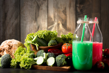 Fresh green and red smoothie in the glass on black stone, Lifestyle concept