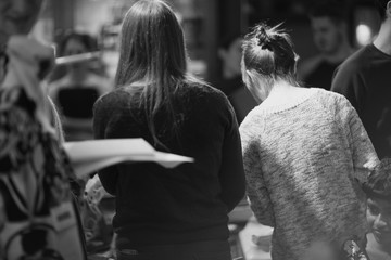 Rear view of female students standing in museum