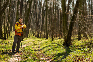 Male hiker looking to the side walking in forest