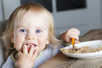 Baby eats porridge spoon mashed